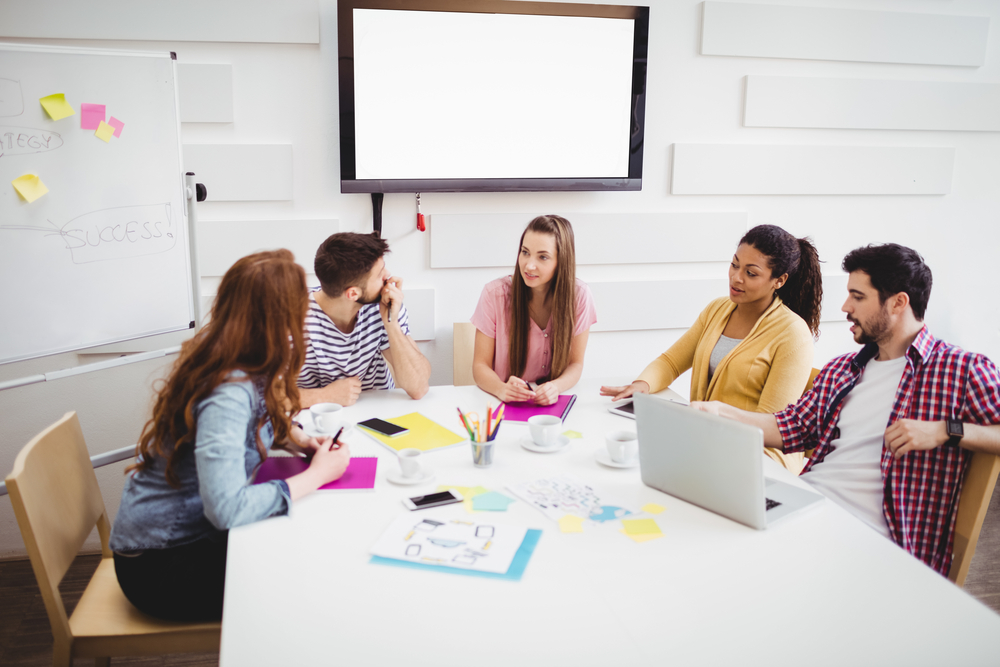 Young partners discussing in meeting at creative office